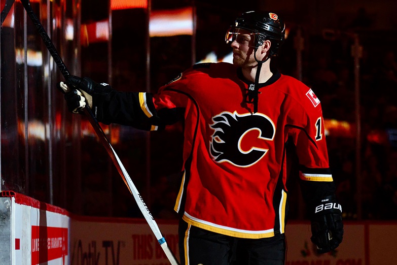 Theoren Fleury's #14 has not yet been retired by the Calgary Flames. He is  second all-time in points with the franchise, won a Stanley Cup and was  briefly their captain, all while